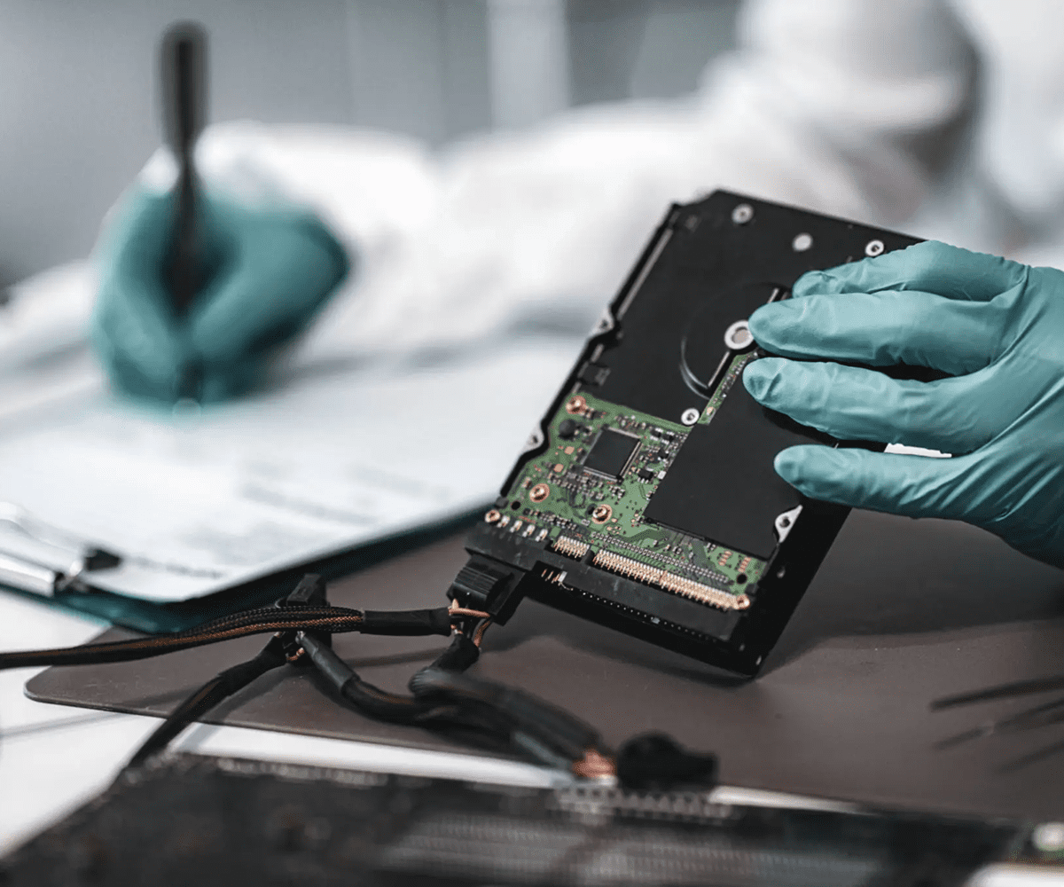 Technician repairing a smartphone with tools and notes.